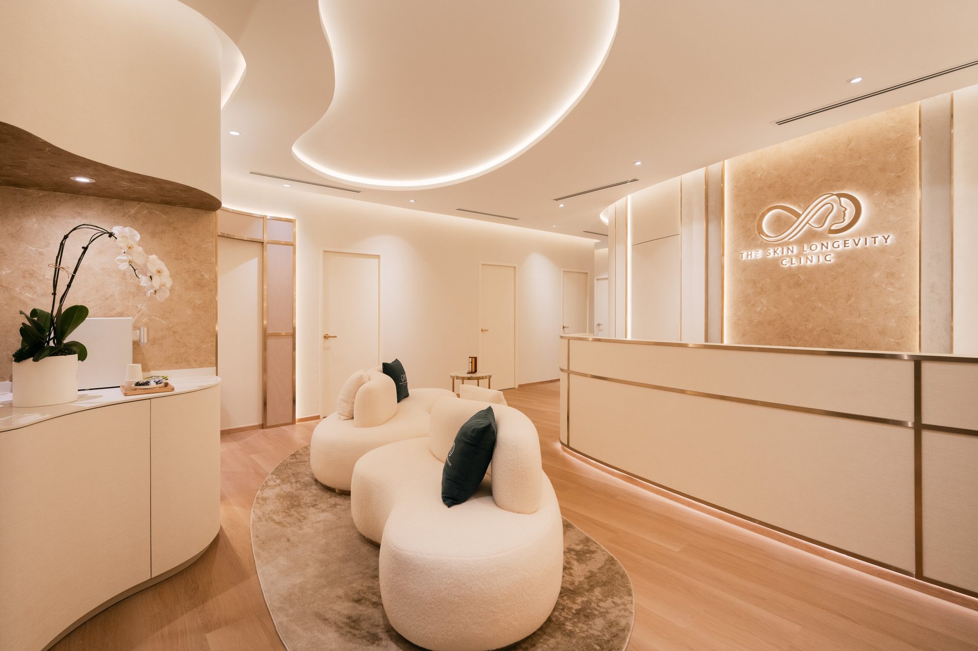 Reception and waiting area with treatment room doors at The Skin Longevity Clinic, Orchard, Singapore